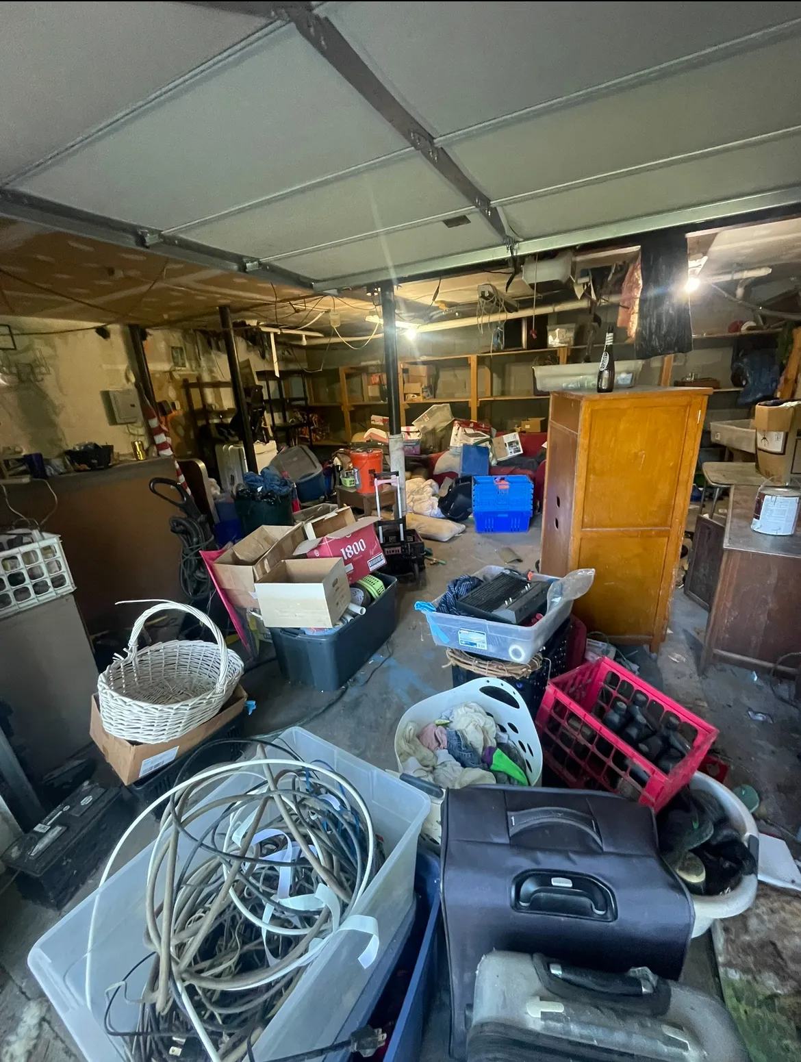 Basement with lots of clutter before junk removal