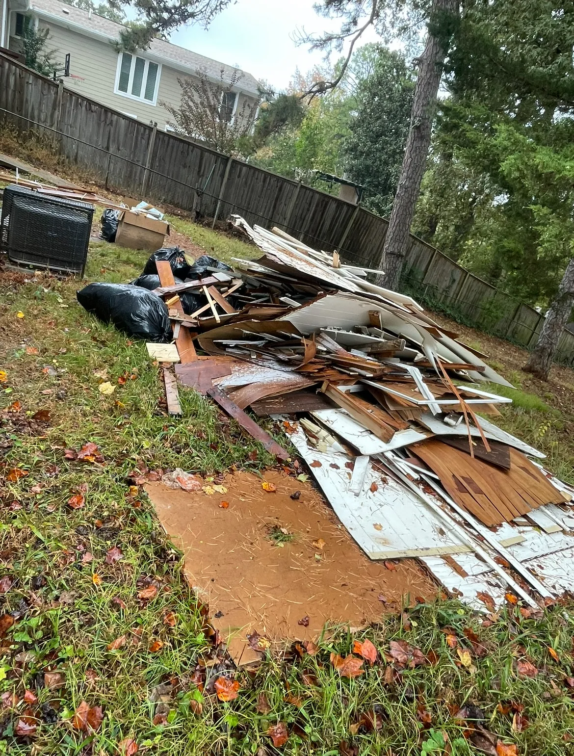 Outside area with construction debris before junk removal